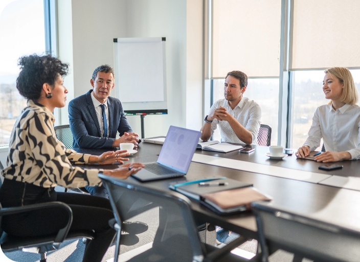 A meeting between in a boardroom is shown